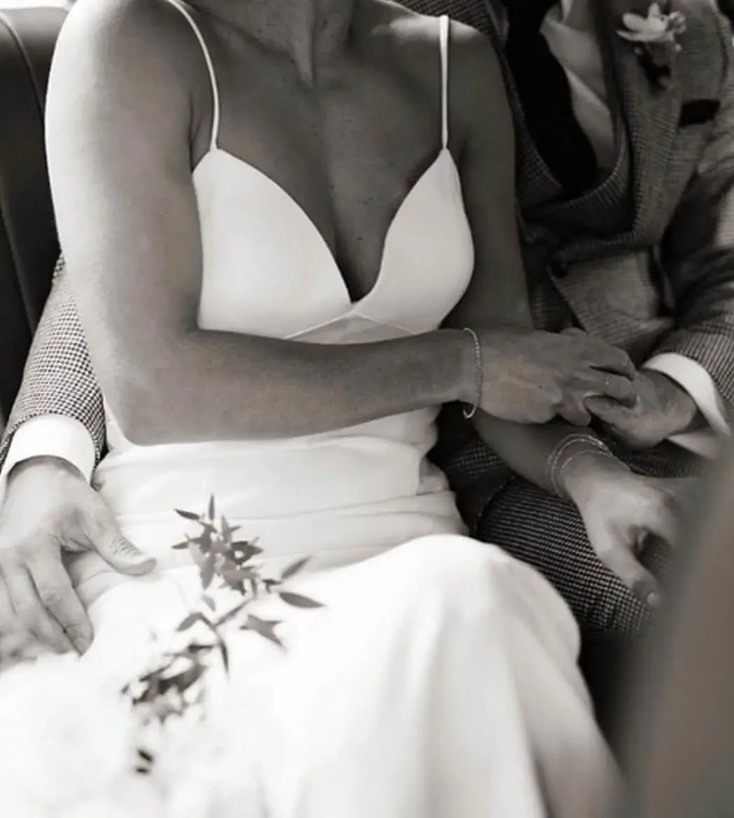 Image 29: Сouple wearing a white gown and a gray suit