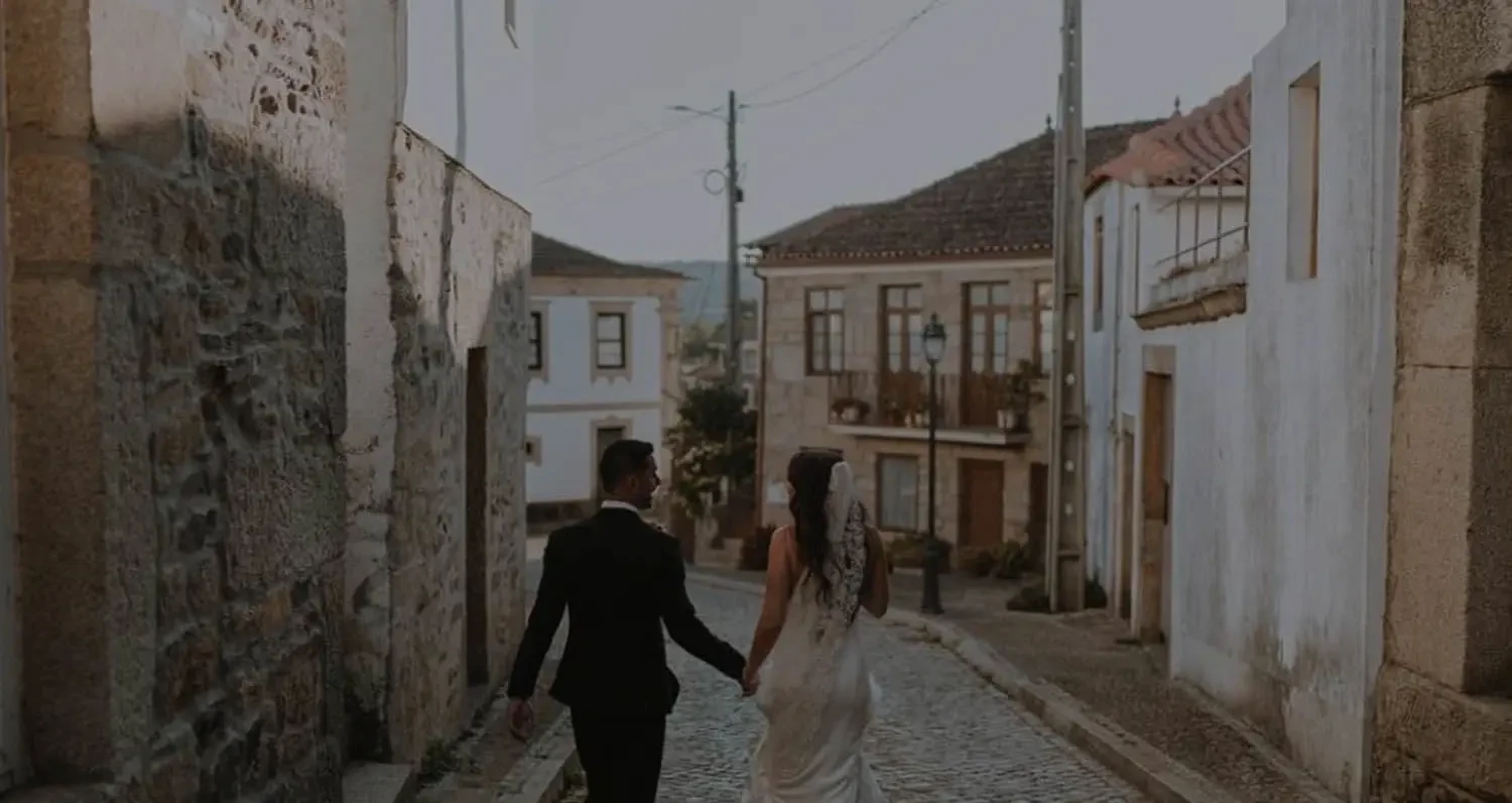 Image 45: Сouple wearing a white gown and a black suit. Mobile image