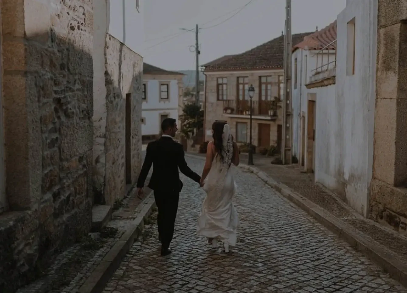 Сouple wearing a white gown and a black suit