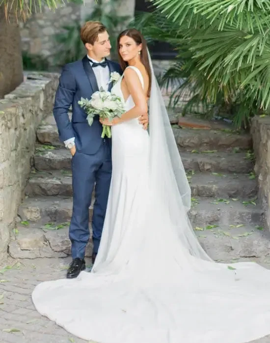 Сouple wearing a white gown and a blue suit