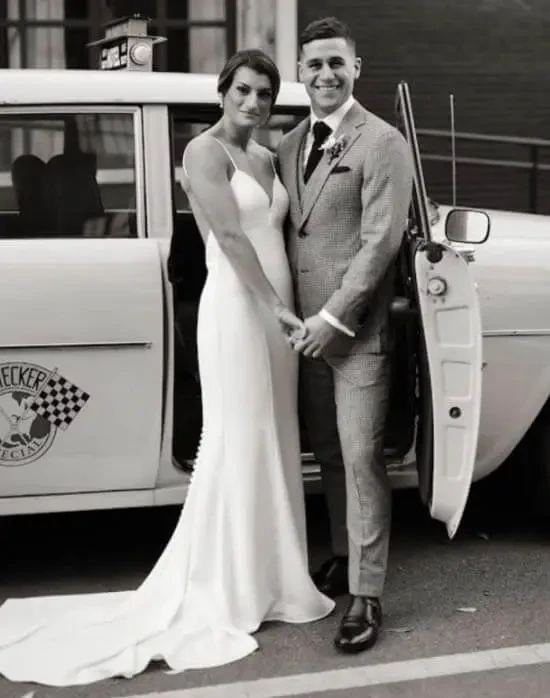 Сouple wearing a white gown and a gray suit