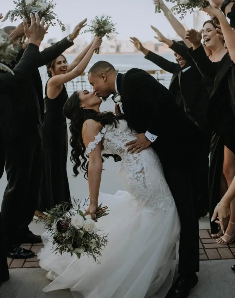 Сouple wearing a white gown and a black suit