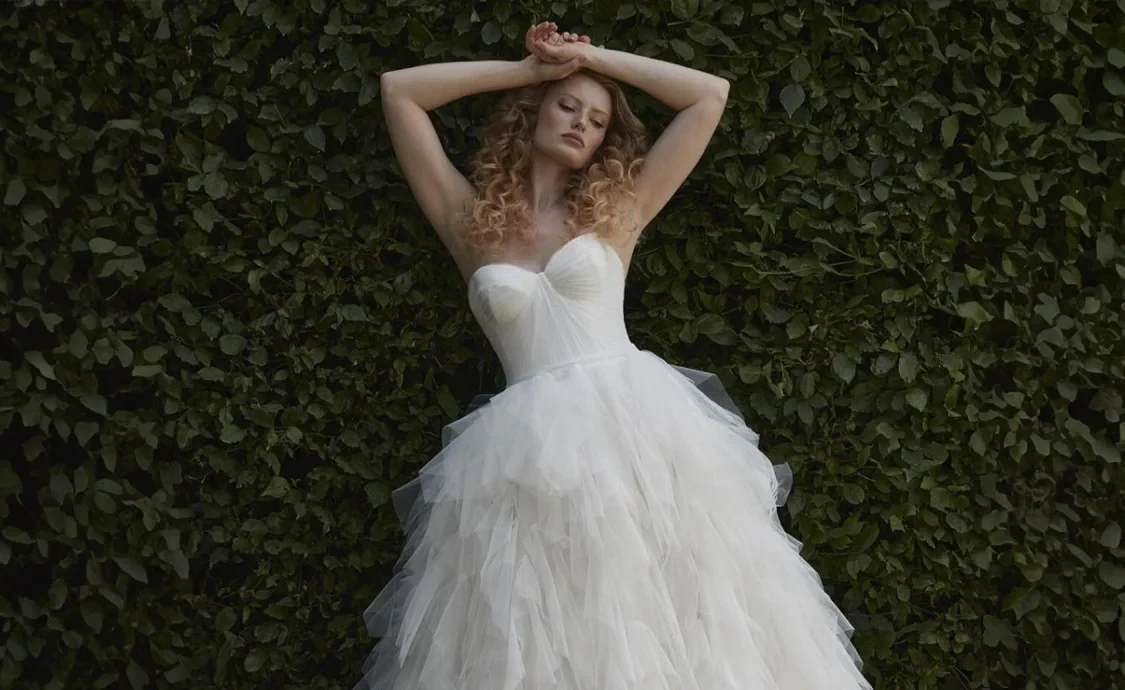 Image 47: Model wearing a white gown by Karin Shemesh. Mobile image