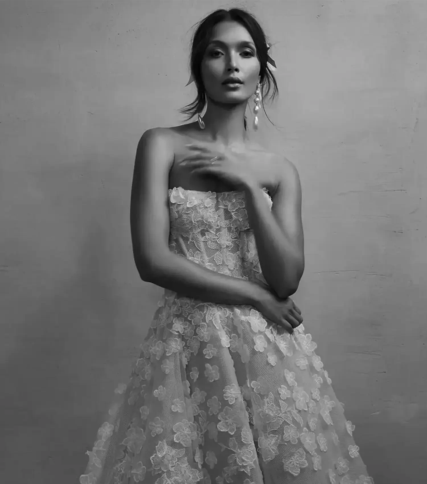 Image 21: Model wearing lace bridal gown
